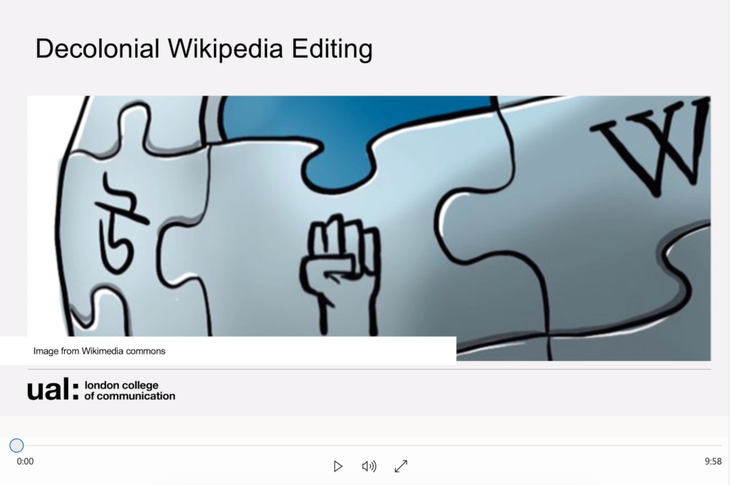 A screenshot of a video. The text 'Decolonial Wikipedia Editing' is at the top, and there is an image of some of the Wikipedia globe jigsaw graphic with a raised fist in one of the pieces.